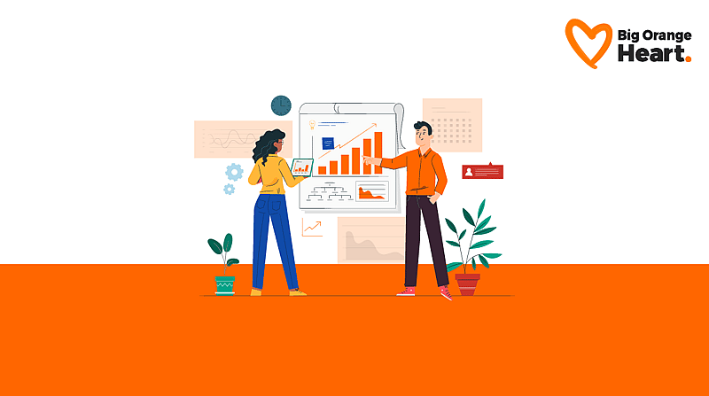 Two people speaking to each other at a wall chart