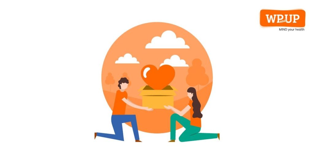 illustrated image of two people kneeling together holding a box with an orange heart in it