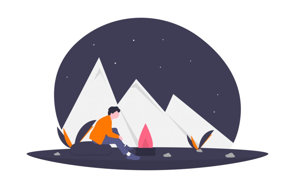 lone person outside at night with a campfire, mountains in the background
